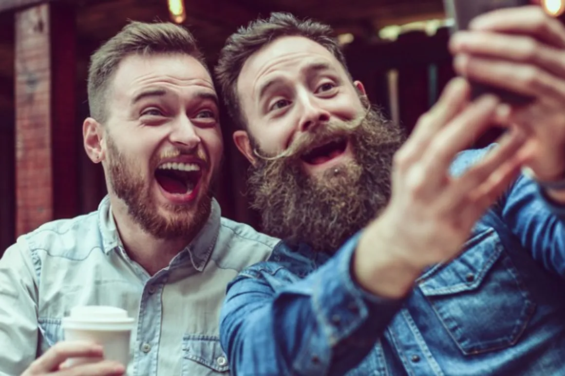 two bearded friends drinking coffee and taking selfie in restaurant picture id869915412 150x150